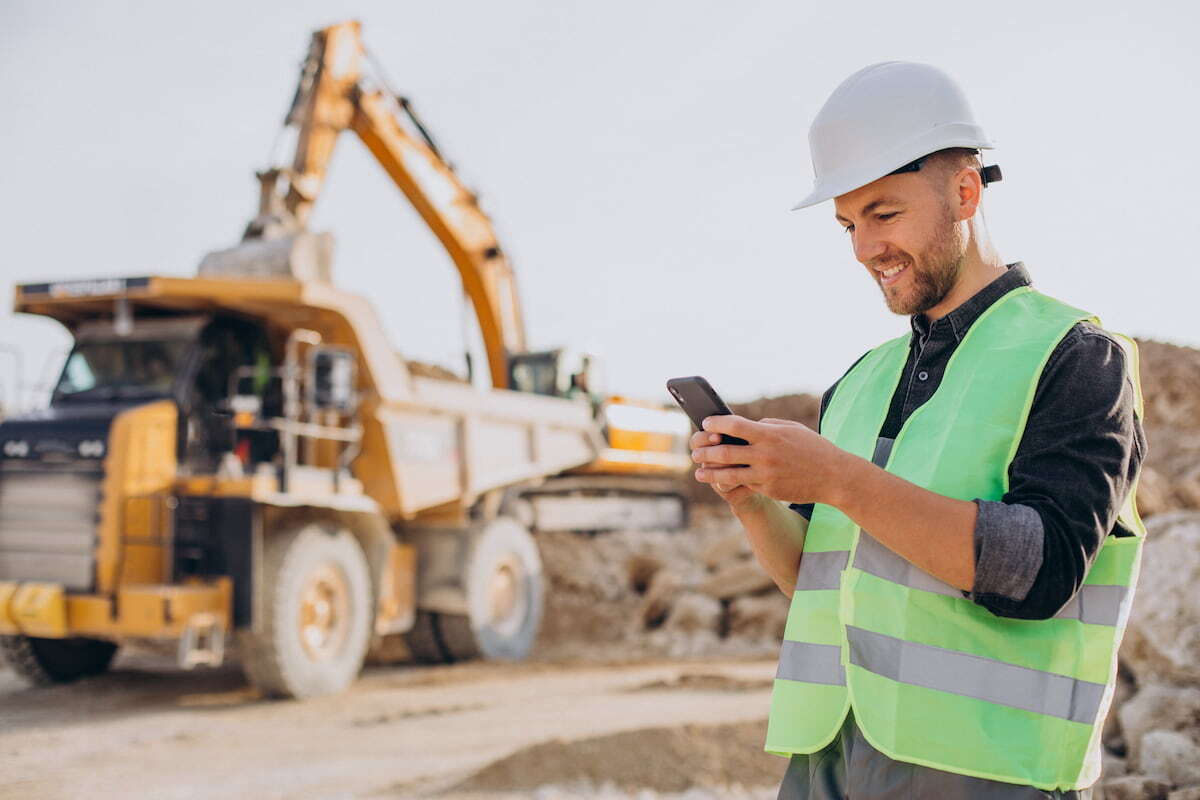 male-worker-with-phone-bulldozer