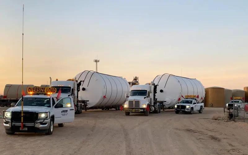 2 fiberglass tanks being transported