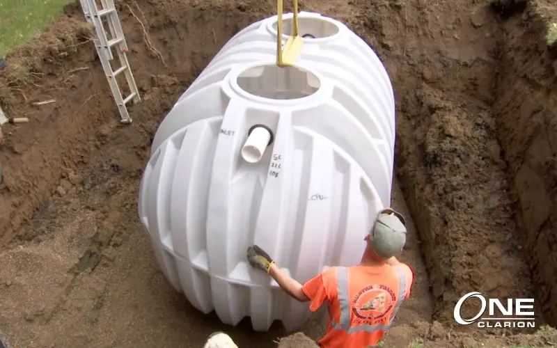 372-0548-septic-tank-installation-man-holding-tank-800x500-022026